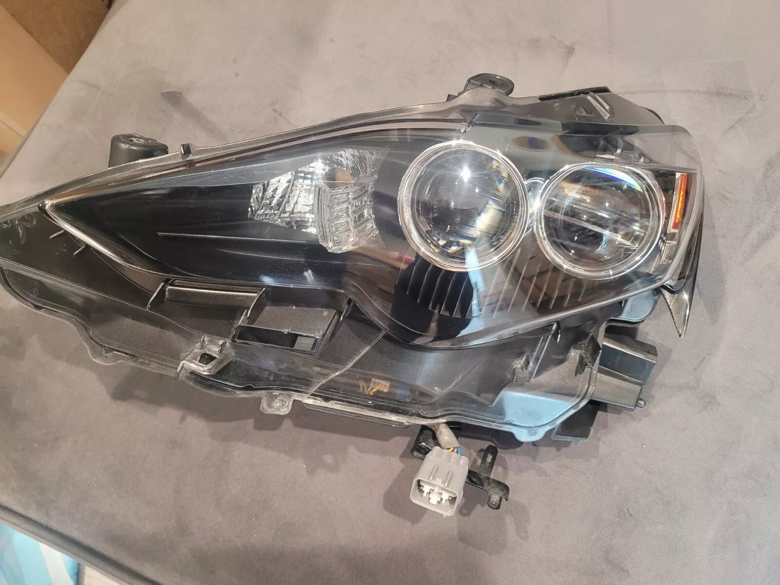 A car headlight is shown with the lights on.