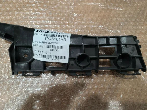 A black plastic part with numbers on it.