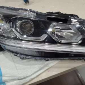A car headlight that is broken and has been repaired.