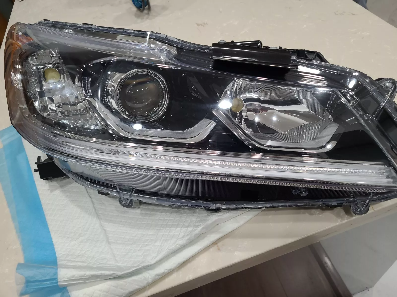 A car headlight that is broken and has been repaired.