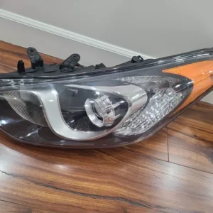 A car headlight on the floor of a room.