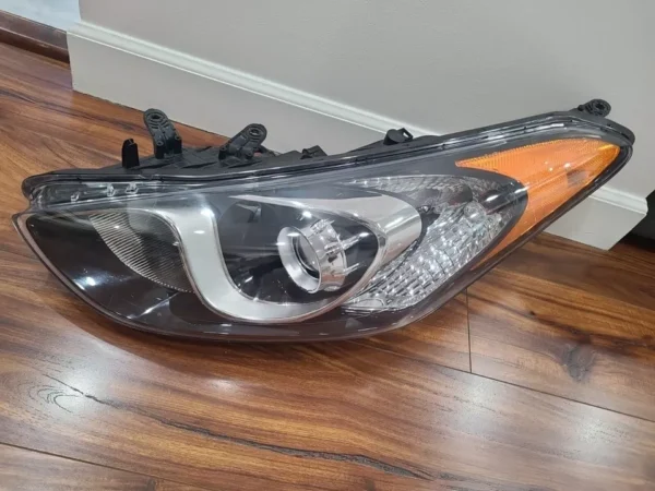 A car headlight on the floor of a room.