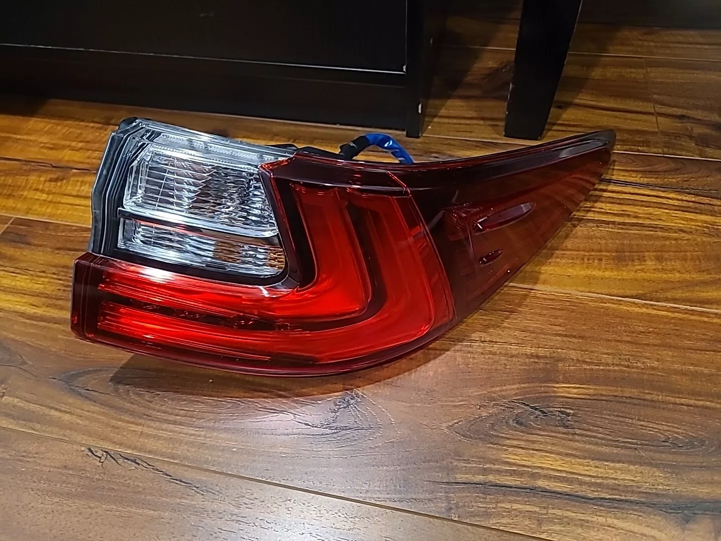 A red and white car tail light on the floor