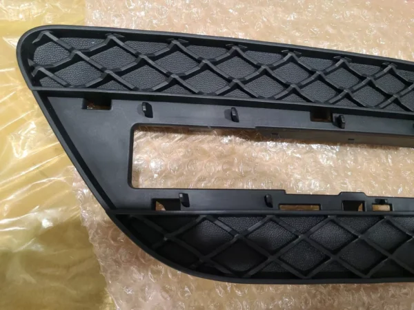 A black plastic part of the front bumper.