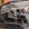 A car headlight with its reflection of the lights.