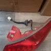 A red tail light sitting on top of the floor.
