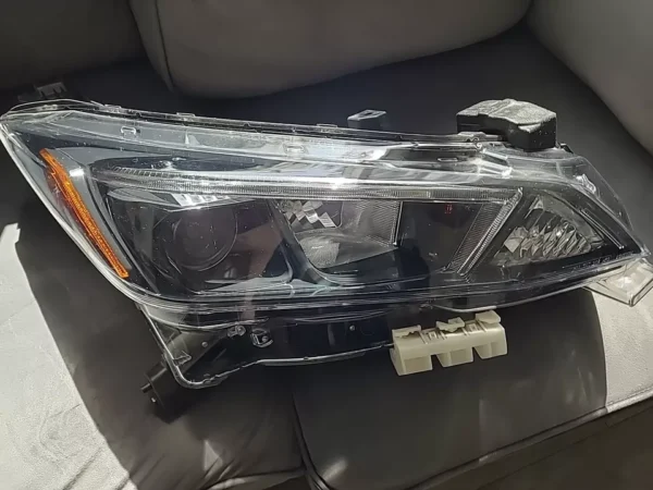 A car headlight sitting on top of the couch.