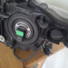 A car 's headlight is broken and has been replaced.