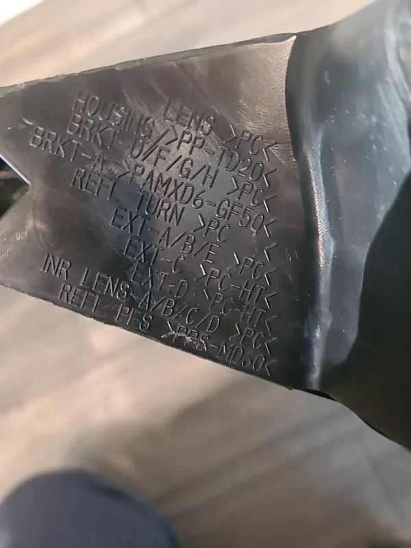 A metal sheet with writing on it.