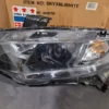 A car headlight that is broken and has been repaired.