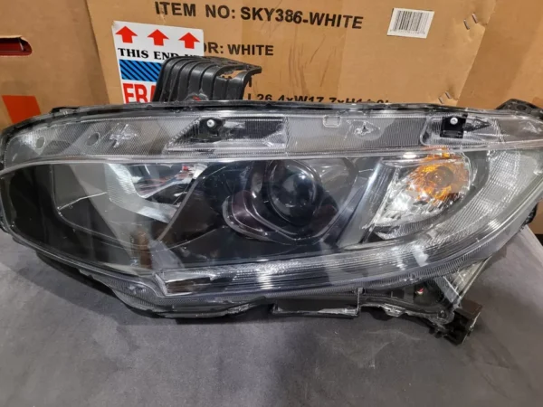 A car headlight that is broken and has been repaired.