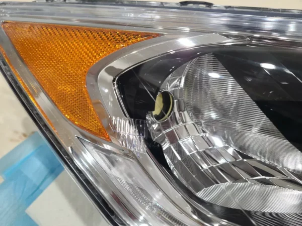 A close up of the headlight on a car.