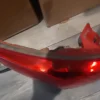 A red skateboard with lights on the bottom of it.