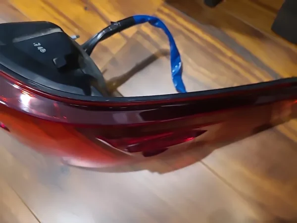 A red and black glass object on the floor