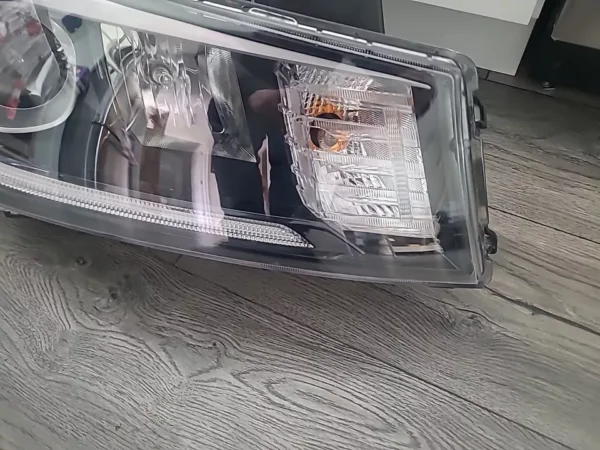 A car headlight with newspapers in it.