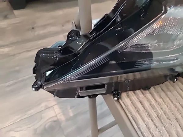 A black bag sitting on top of a wooden table.