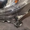 A car headlight with the hood up.