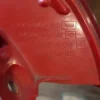 A red piece of metal with some writing on it