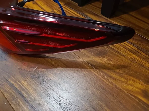 A red object sitting on top of a wooden floor.