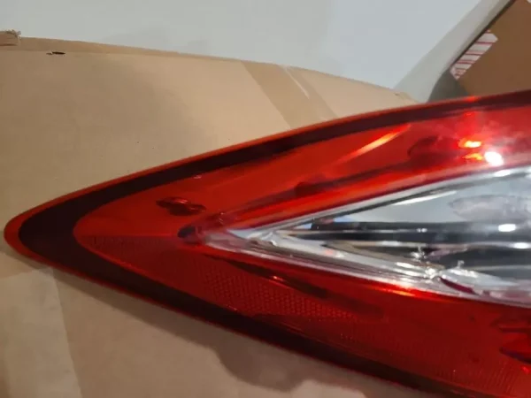 A red tail light is shown on the side of a car.