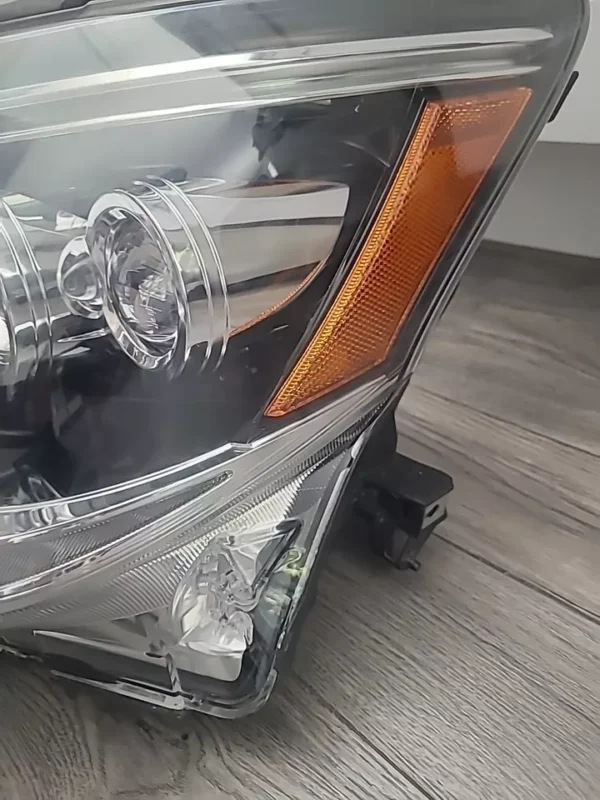 A car headlight with the lights on.