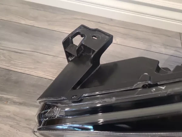 A black metal object sitting on top of a wooden floor.