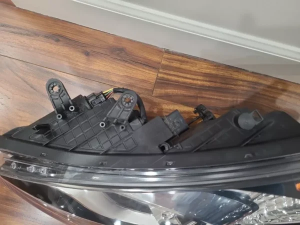 A black piece of metal sitting on top of a wooden floor.