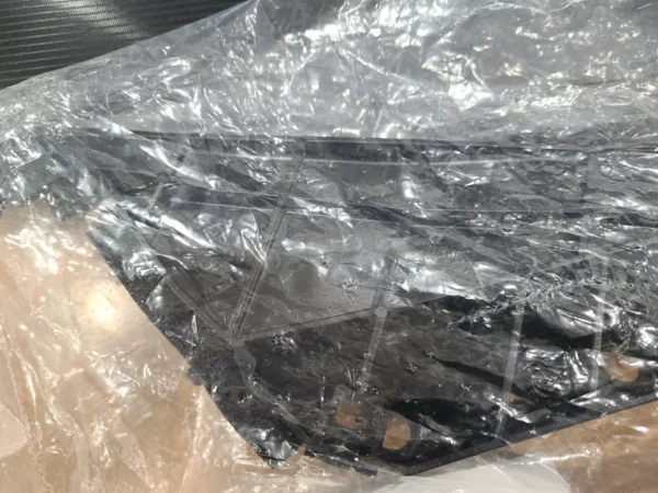 A black plastic bag with some sort of material on it