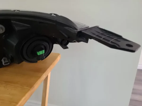 A black remote control car on top of a wooden table.