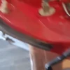 A red table with a metal top and wooden legs.