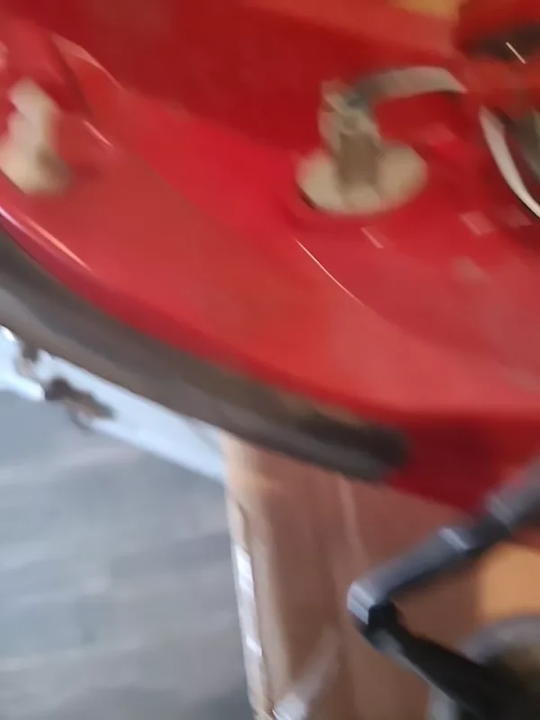 A red table with a metal top and wooden legs.