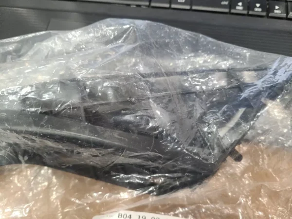 A plastic bag wrapped around a laptop computer.