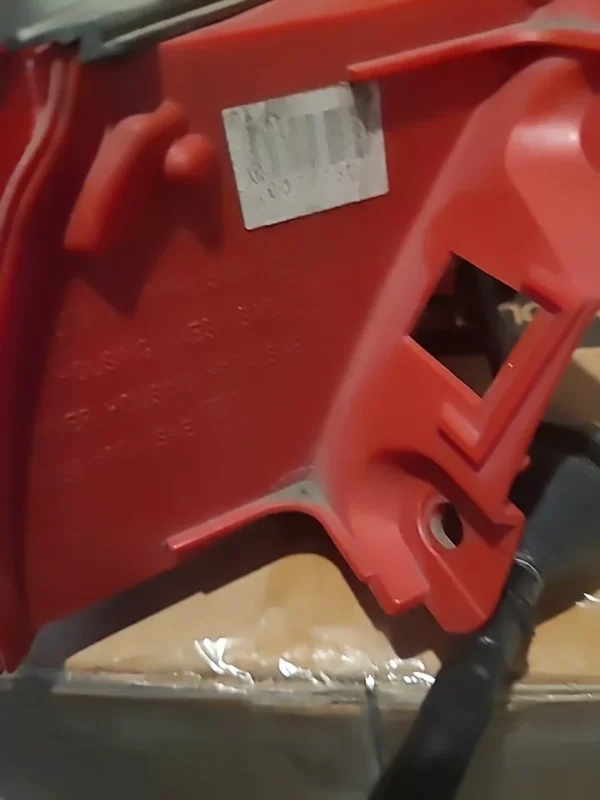 A red piece of plastic sitting on top of a table.