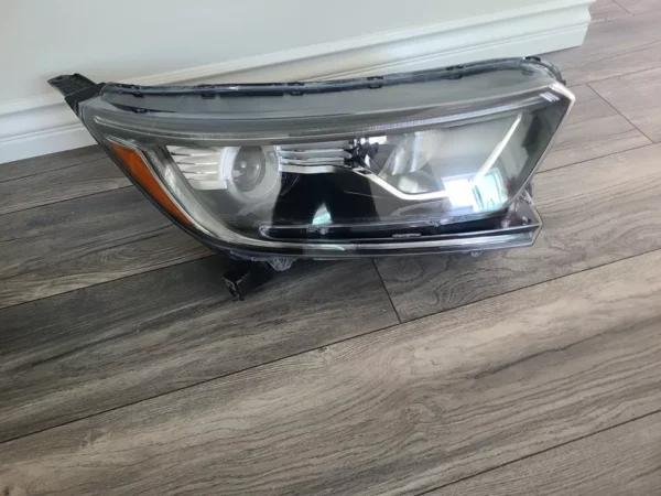 A car headlight sitting on the ground.