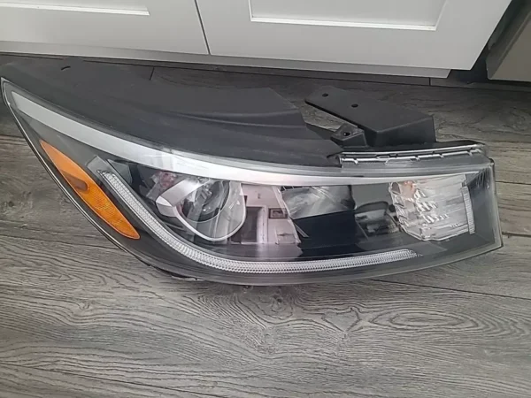 A car headlight on the floor of a house.