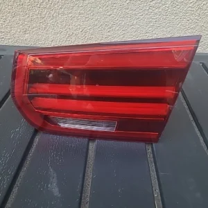Close-up of a red car taillight with distinct horizontal lines.