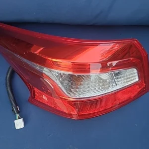 Close-up of a red car tail light with wiring attached.