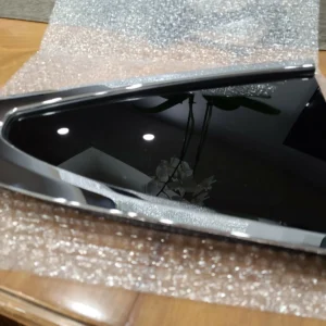 A cracked smartphone screen lying on bubble wrap.