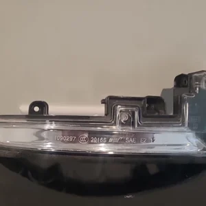 Close-up of a metallic object with engraved numbers and letters.