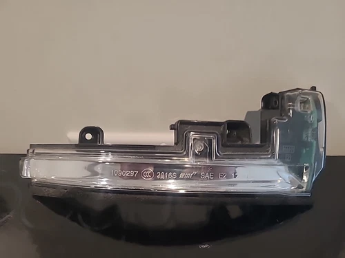 Close-up of a metallic object with engraved numbers and letters.